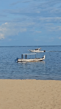 Morning beach life captured in Denpasar: cycling, sailing, music