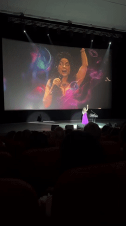 Musical concert featuring purple-dressed performer draws audience in Novosibirsk theater