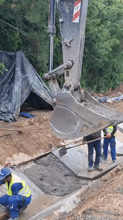 Concrete drainage channel going in along a Hîncești roadside