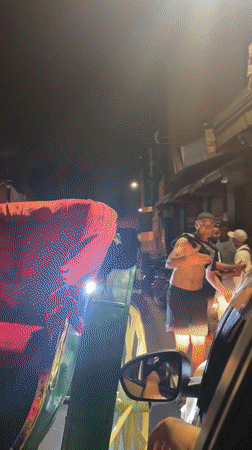 Horse-drawn carriage and street crowds in nighttime Marrakesh