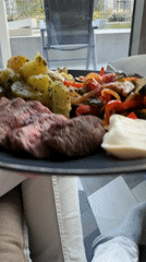 Person enjoys steak dinner with vegetables in Amsterdam