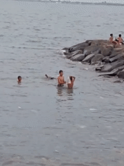 Children play soccer, swim near fishing boats in Lhokseumawe