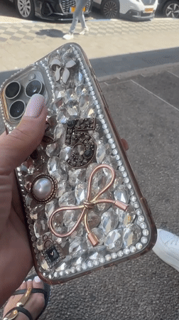 Woman displays jeweled iPhone case on Netanya street