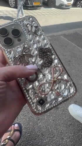 Woman displays jeweled iPhone case on Netanya street