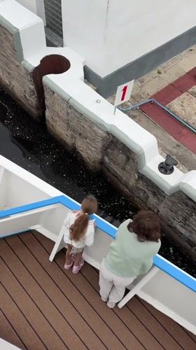 Looking down into a canal lock from a passing boat