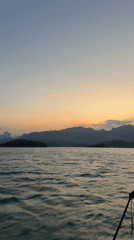 Sunset boat journey documented across Thai lake near Ban Chiao Lan