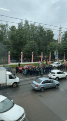 Flag-carrying march proceeds through Izhevsk with uniformed escorts