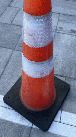 Praying mantis claims an orange traffic cone in Chișinău