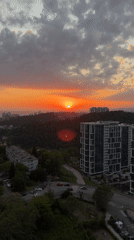 Vivid sunset documented across Sochi cityscape and wooded areas