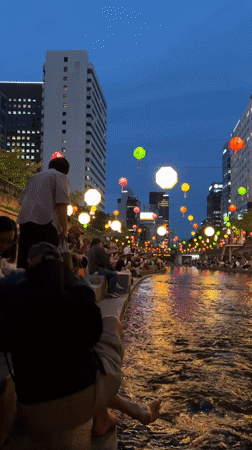 Seoul waterway draws evening crowds under decorative lanterns
