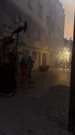 Traditional festival with costumed performers, floats observed in Barcelona