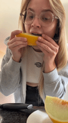 Woman enjoys morning melon in Tel Aviv kitchen