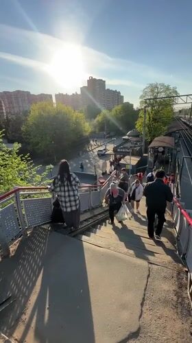 Group walks down train station overpass in Lyubertsy