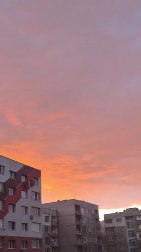 Sunset with orange-pink clouds captured over Pernik buildings