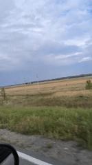 Road trip through open rural countryside on a cloudy day