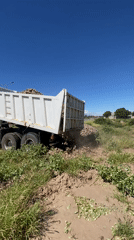 Bulldozer operates in muddy field near Catamarca, Argentina