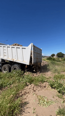 Bulldozer operates in muddy field near Catamarca, Argentina