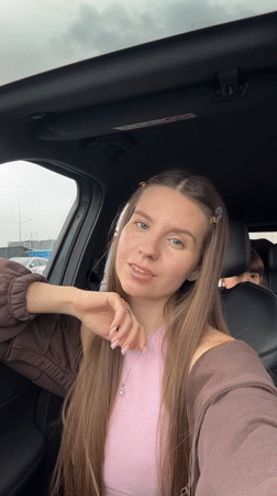 Woman documents selfies in parked car in Russian village