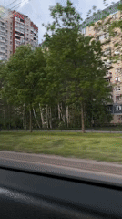 Vehicle passenger records street view of residential buildings in Saint Petersburg