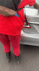 Rollerblading near parked cars in Ilado, Nigeria