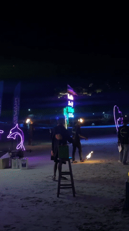 Fire juggler performs on Thailand beach during Full Moon Party