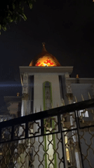 Illuminated mosque dome observed in nighttime Kaliwates street scene