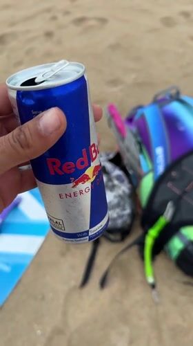 Kitesurfing gear and busy water at a Bali beach