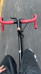 Cyclist rides through Buenos Aires street on evening commute