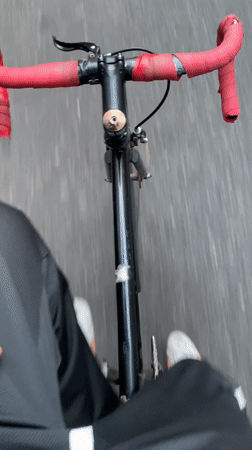 Cyclist rides through Buenos Aires street on evening commute