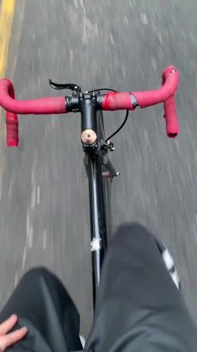 Cyclist rides through Buenos Aires street on evening commute