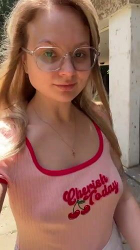 Woman films herself walking dog on Bat Yam sidewalk