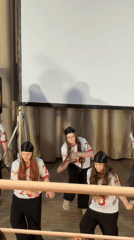 Young dancers perform hip-hop routine in matching baseball jerseys