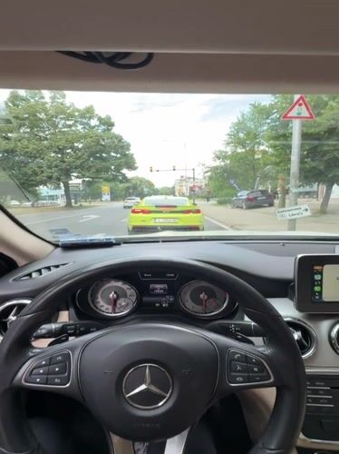 Mercedes driver waits behind green Camaro at Bulgarian traffic light