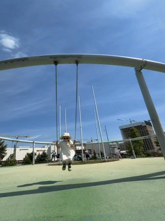 Child enjoys sunny morning playground activities in Khimki, Russia