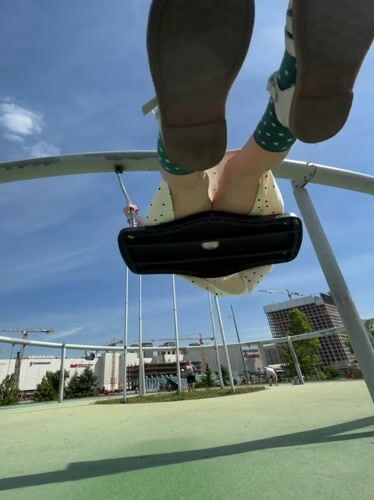 Child enjoys sunny morning playground activities in Khimki, Russia