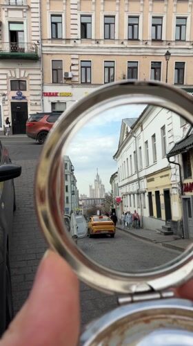 Moscow residents carry daffodils through city streets and cafes