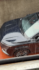 Dark SUV parked in rain in Igboefon, Nigeria