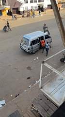 Morning street scene with vans and schoolchildren in Bukuru