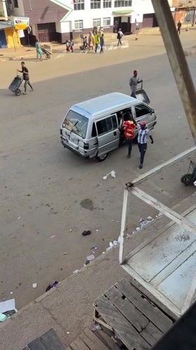 Morning street scene with vans and schoolchildren in Bukuru