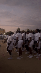 Youth group in white uniforms gather for morning ritual in Maiduguri