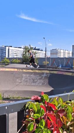 Scooter riders at a sunny Saint Petersburg skate park