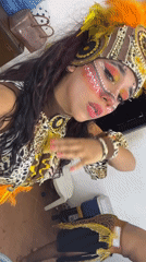 Costumed festival participants document elaborate tribal attire in Porlamar