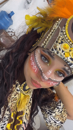 Costumed festival participants document elaborate tribal attire in Porlamar