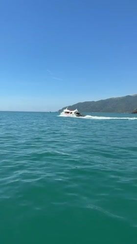 White boat speeds across turquoise waters near Nha Trang
