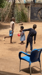 Children play with balloons in Nigerian town yard