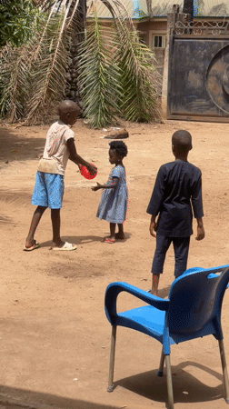Children play with balloons in Nigerian town yard