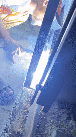 Welder works on metal frame in Banda Aceh