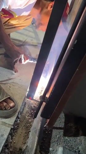 Welder works on metal frame in Banda Aceh