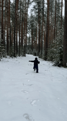 Child plays in snowy forest near Chaikovsky, Russia
