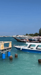 Morning pier activity captured at Indonesian coastal location